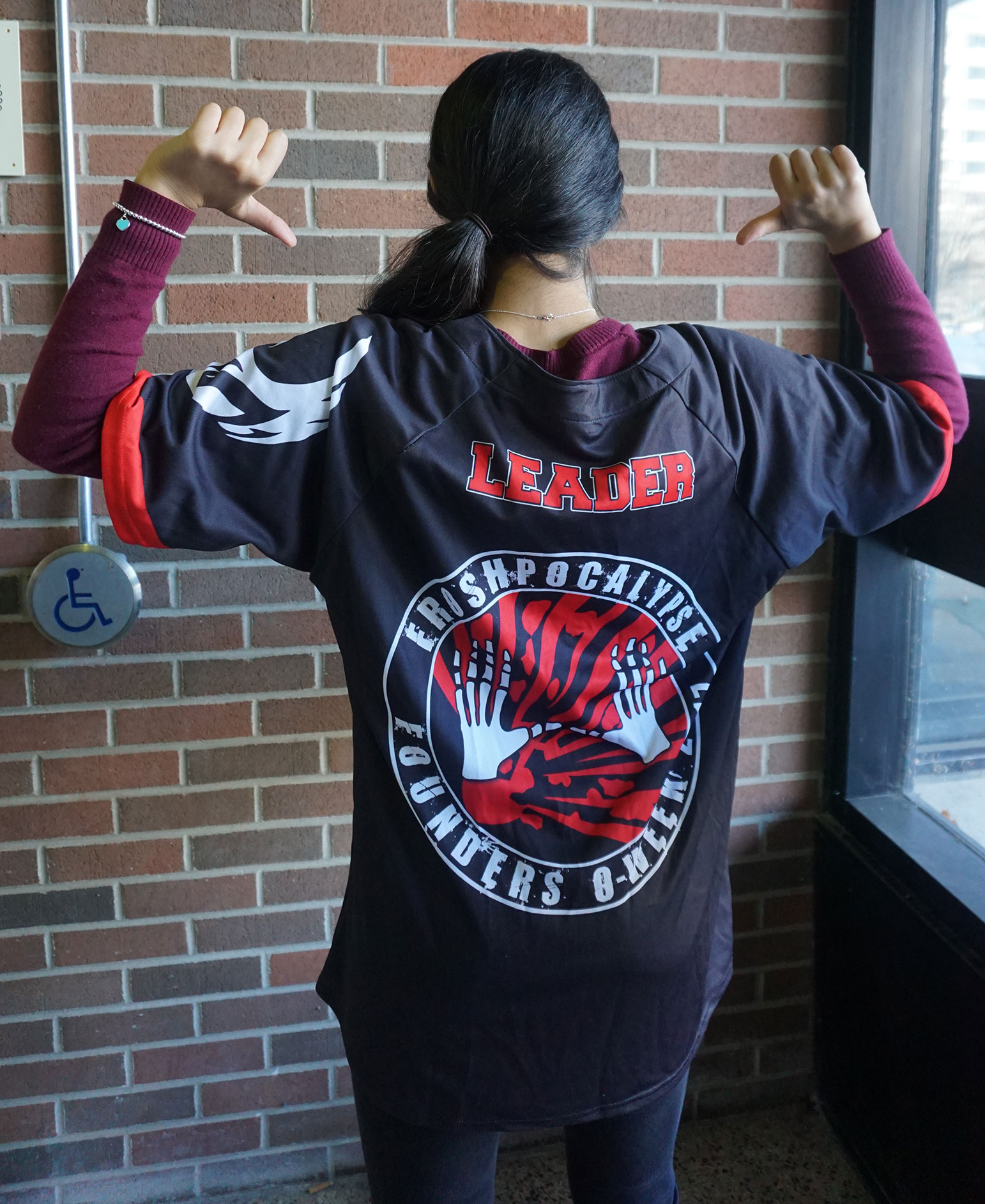 This is a picture of Aliya wearing her Orientation week jersey from Founders College.