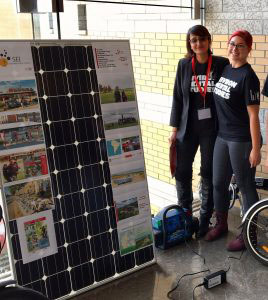 This is a photo of Sany and another student beside a solar panel.
